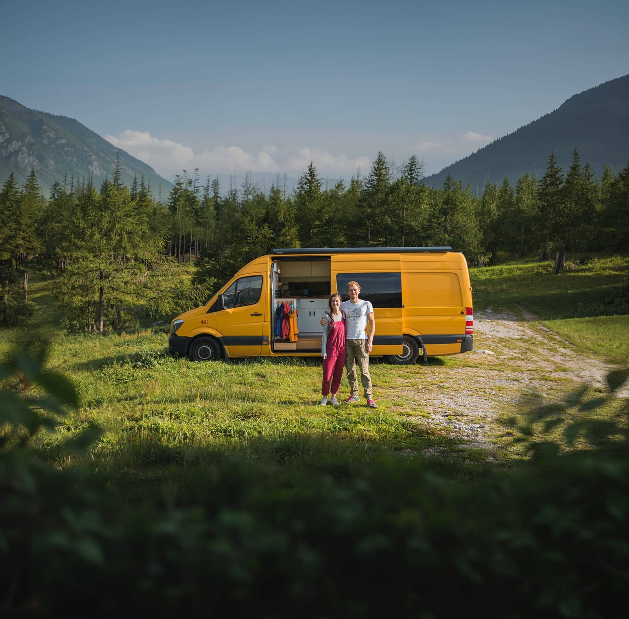 Yellow camper van in mountain landscape