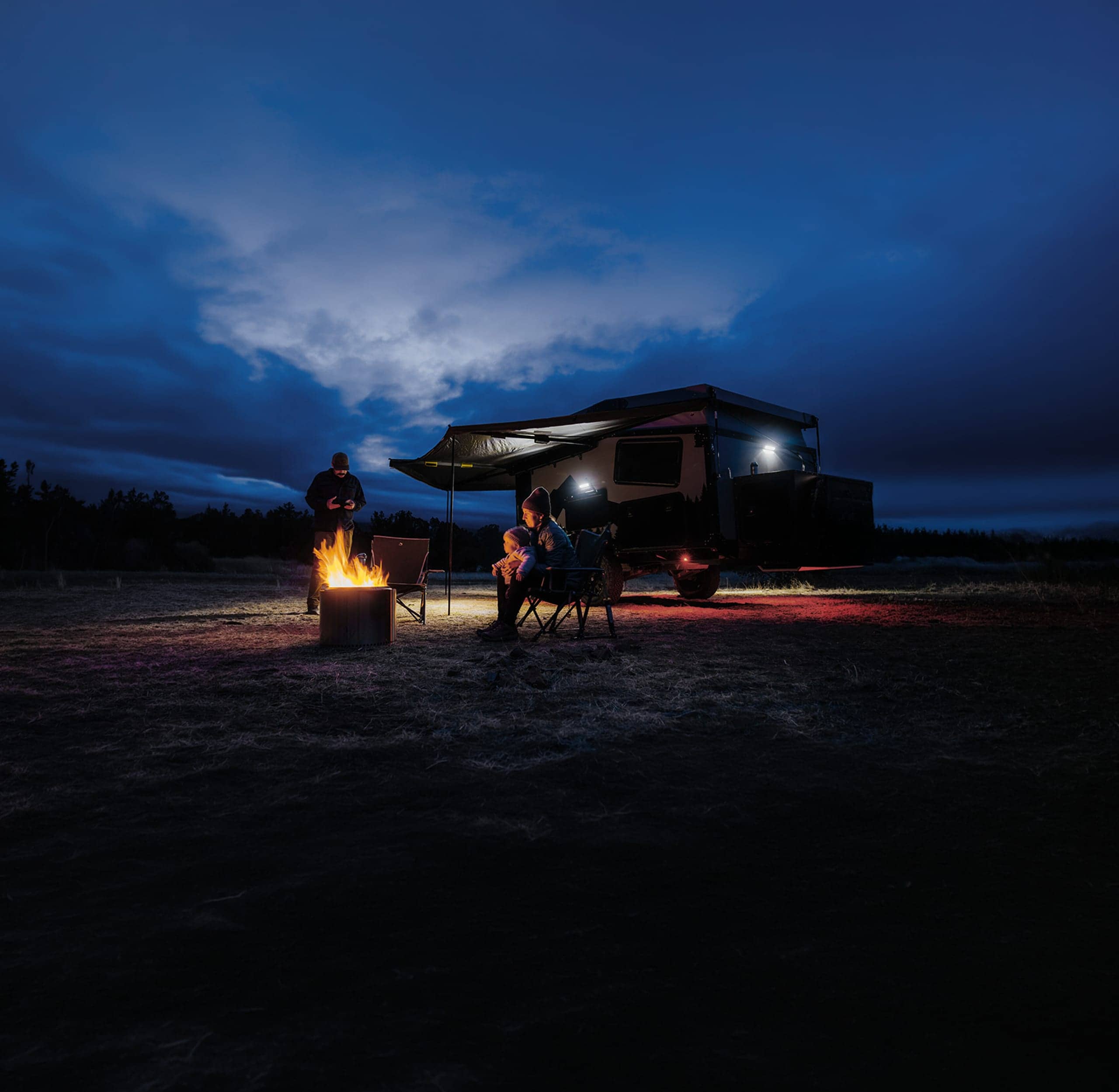 Family camper van parked at night with twinkling lights
