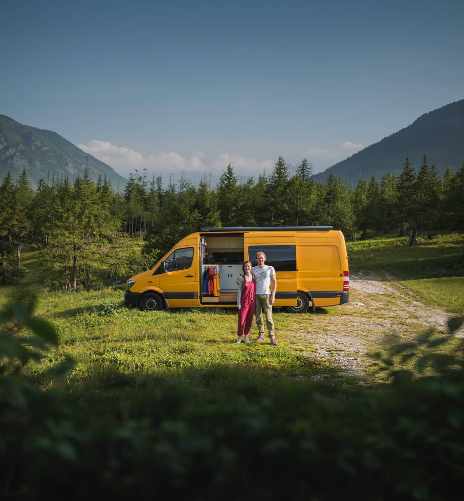Yellow camper van in mountain landscape