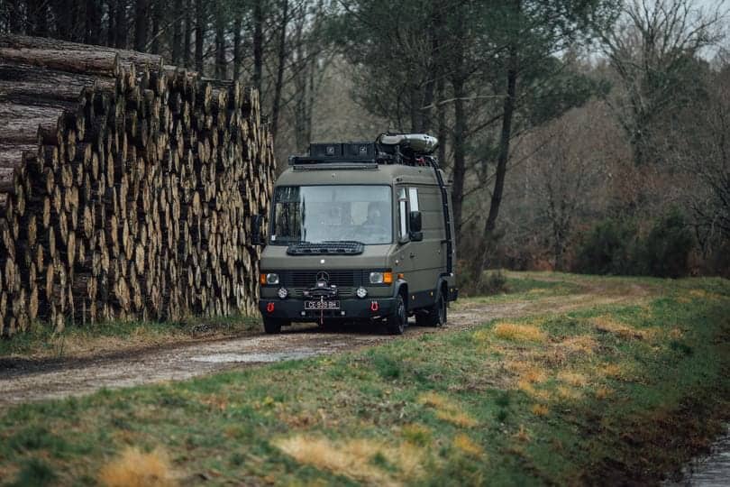 Custom Mercedes camper van parked on a forest track